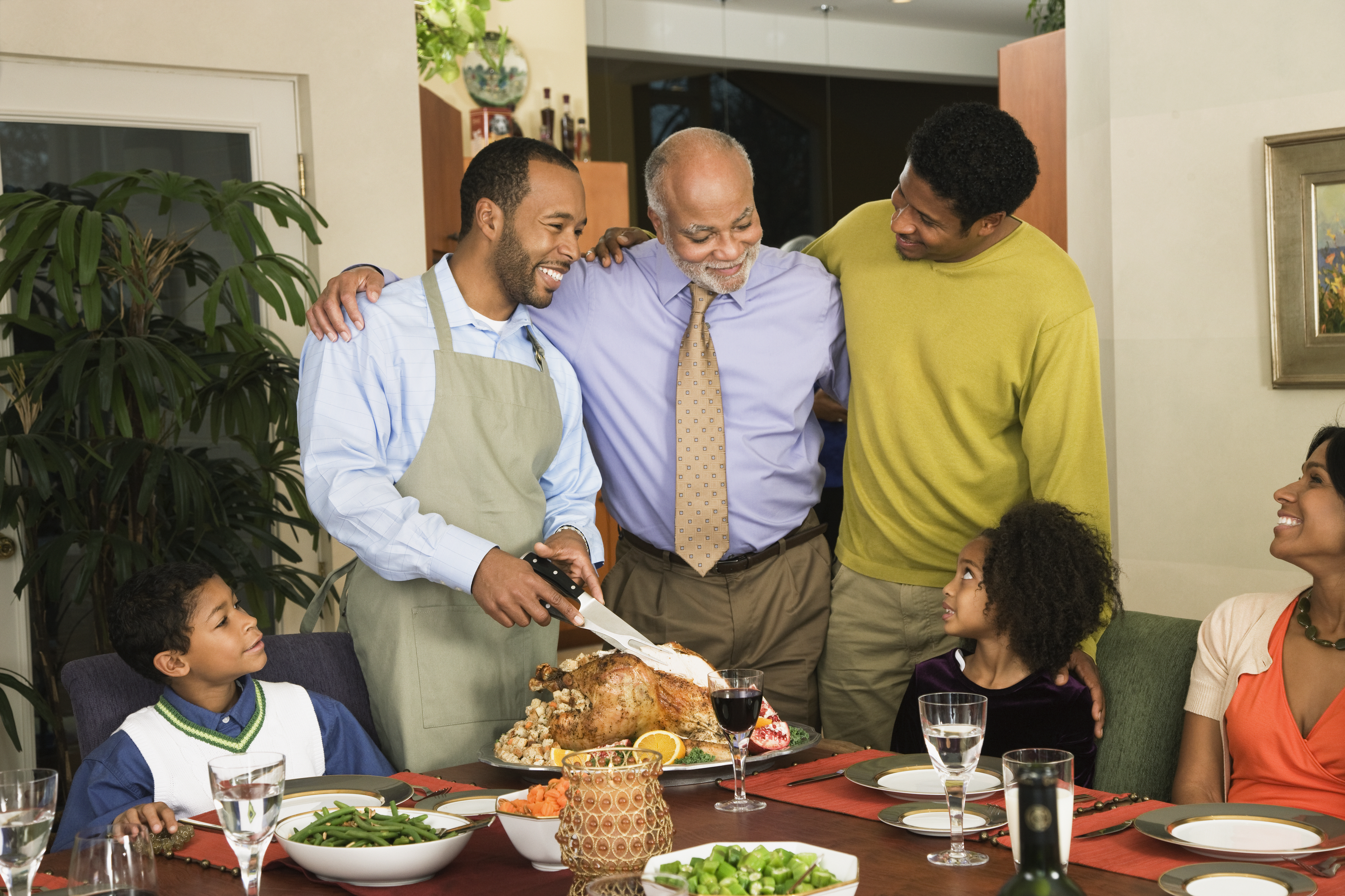 African American man carving Thanksgiving turkey