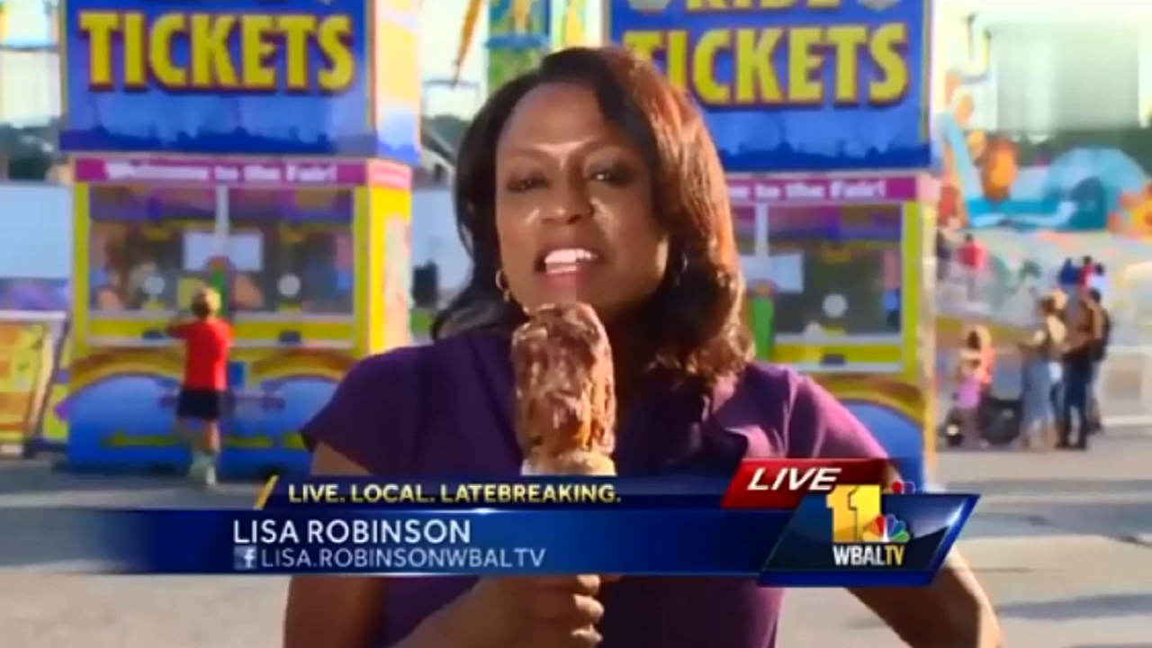 Newcaster Accidentally Mistakes Food-on-a-Stick For Her Microphone