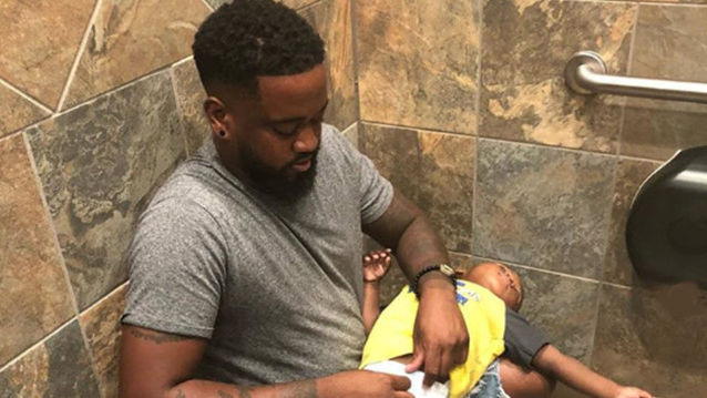 Photo of Dad Using Lap to Change Son's Diaper Goes Viral