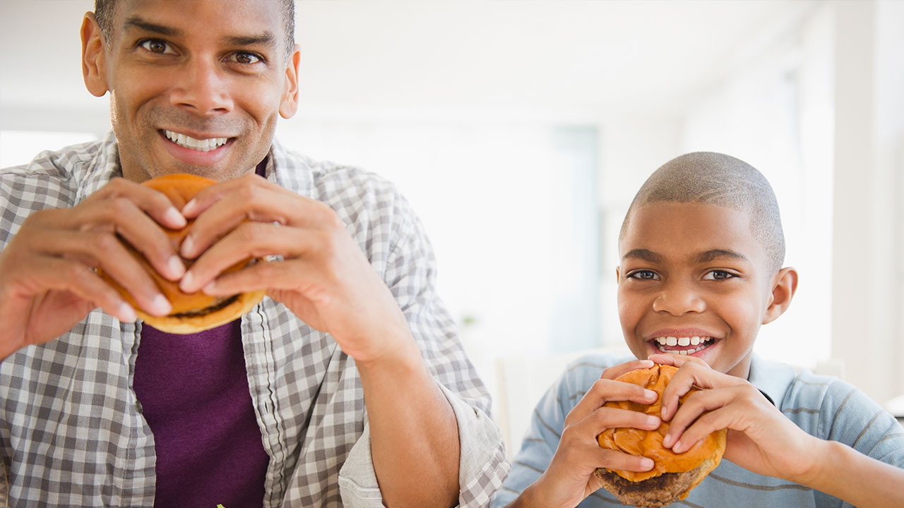 Dad and son eating fast food