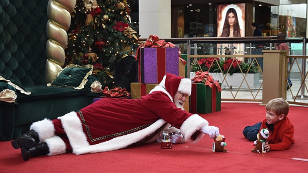 Santa Lays on Floor For Child With Autism