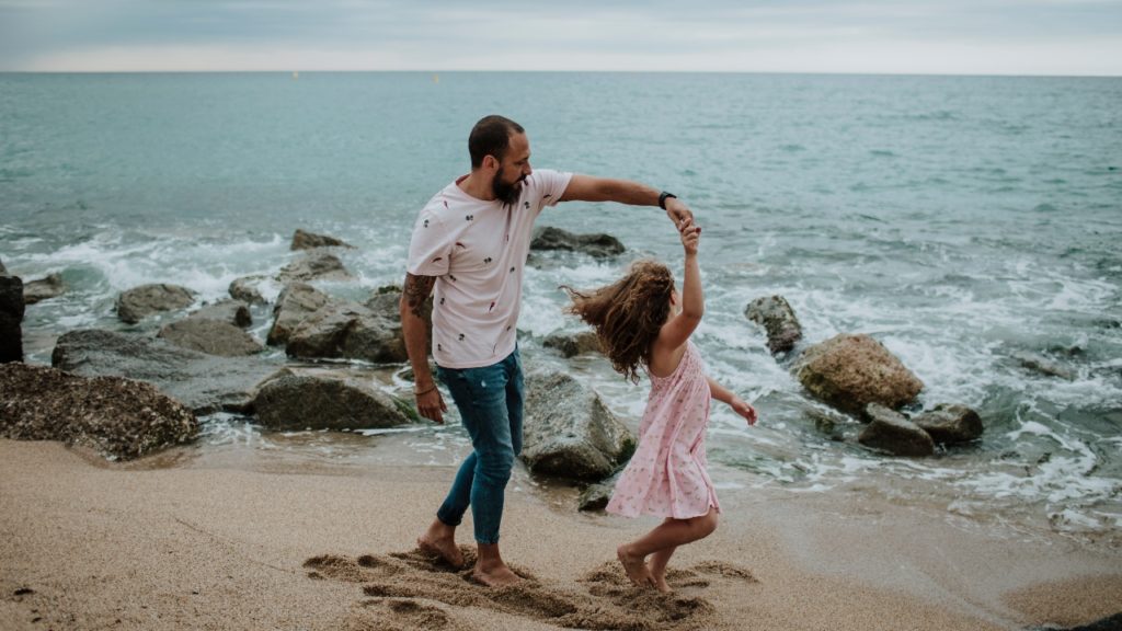 dad and daughter songs, father dancing with daughter on the beach