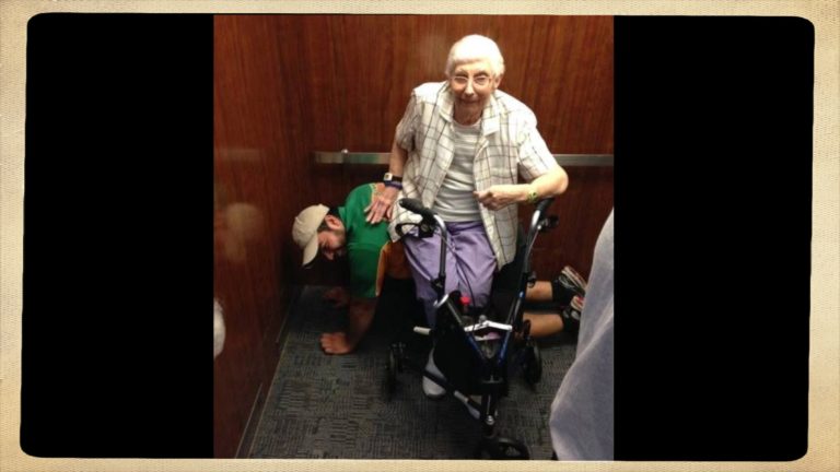 Student acts as human bench after getting stuck in elevator with elderly woman