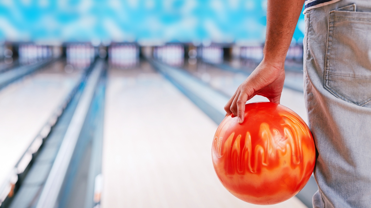 Pin, shoes and ball on alley in bowling club. Space for text Stock