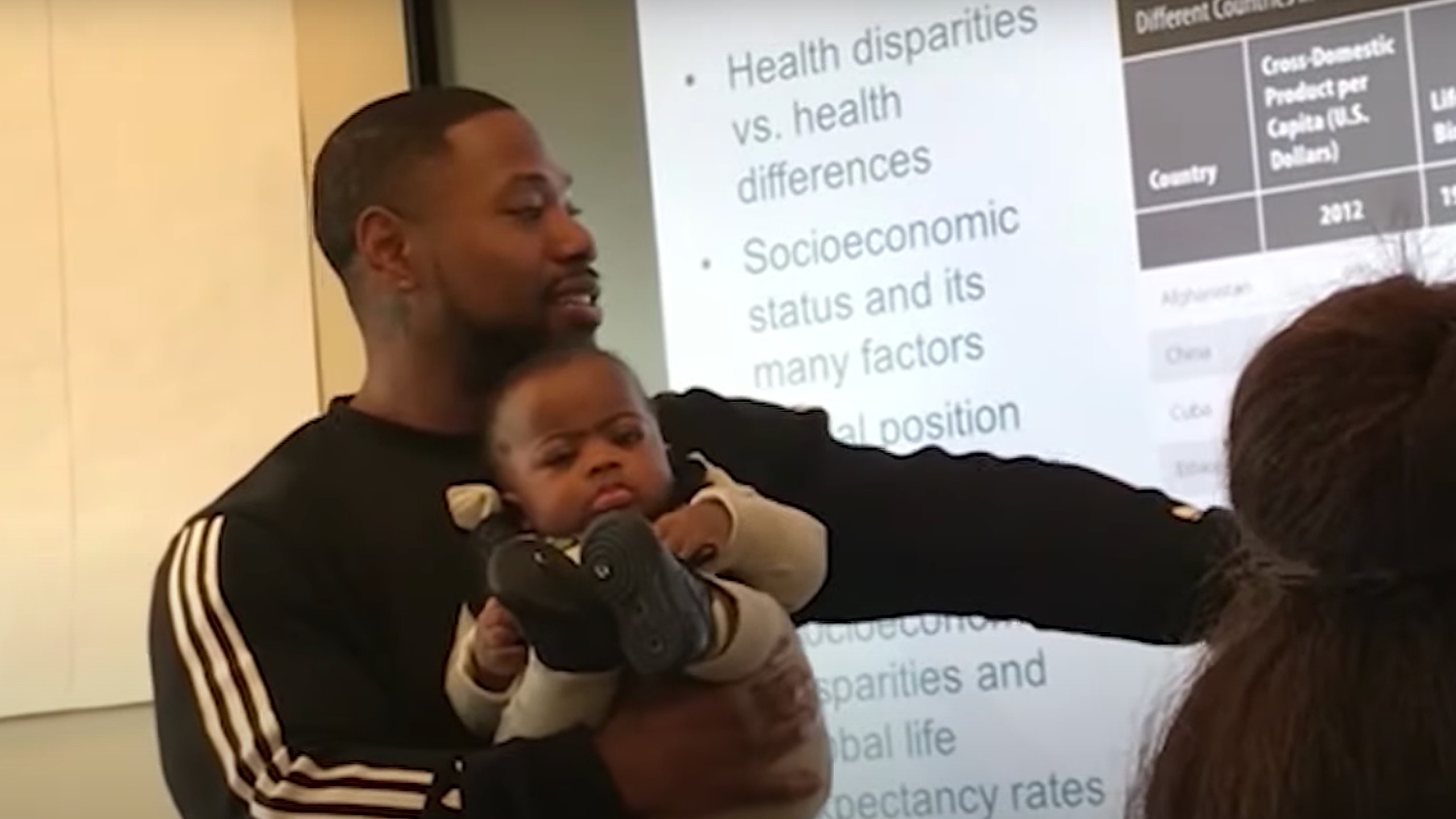 Professor holds baby while he lectures to help student who couldn't find babysitter